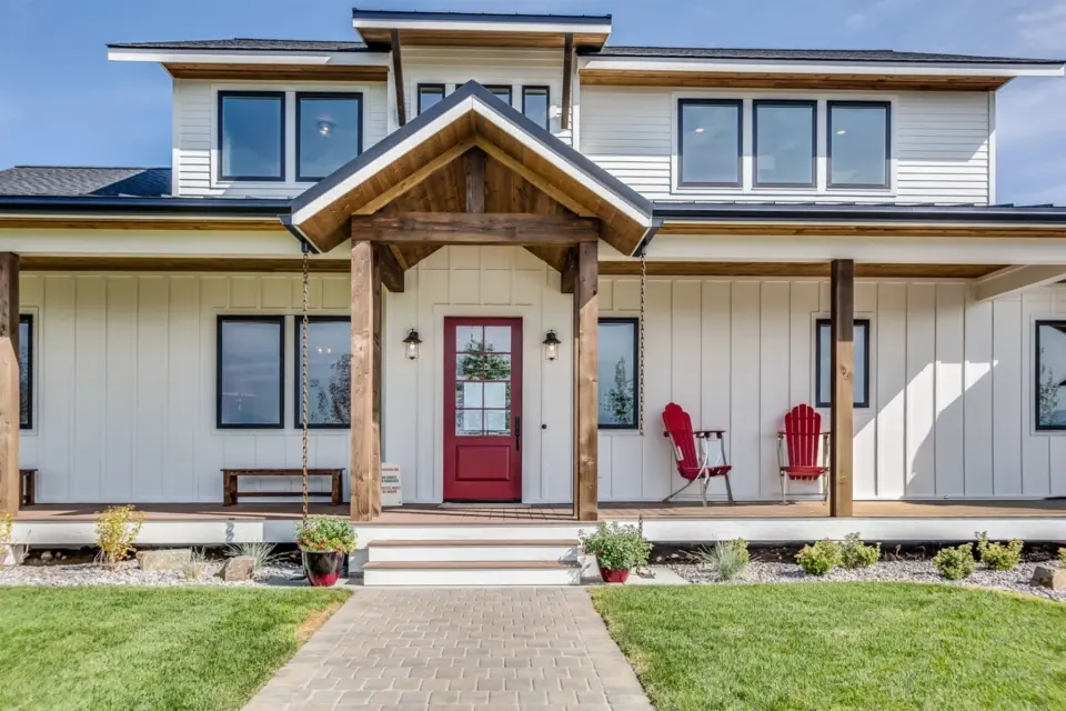 black-trim-windows-and-red-front-door-on-white-house-with-porch-and-wooden-portico-in-seattle-wa